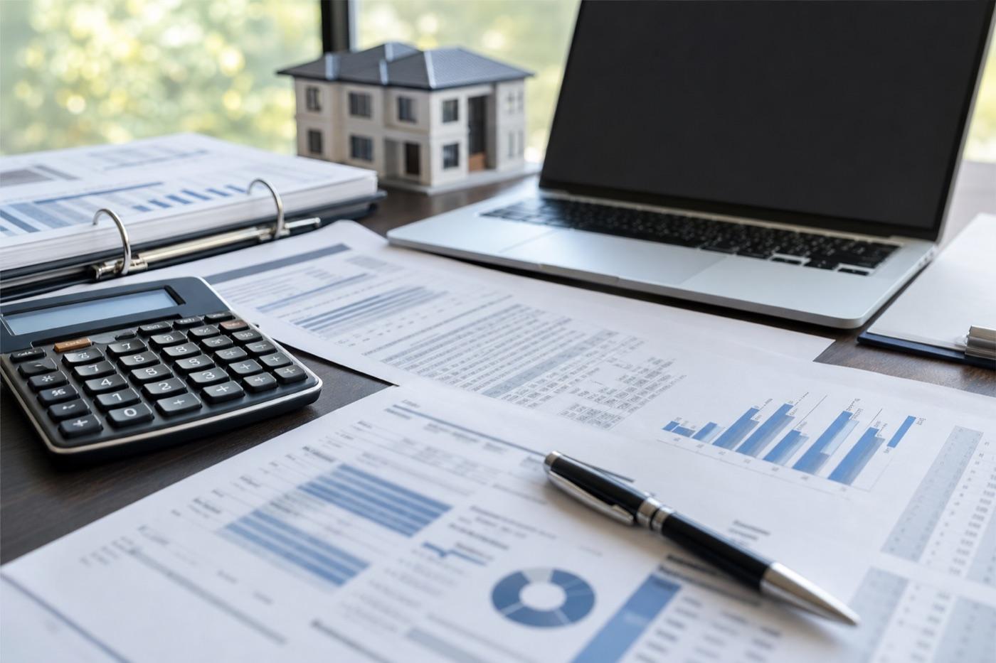 Rental property underwriting documents with calculator and appraisal materials for DSCR analysis