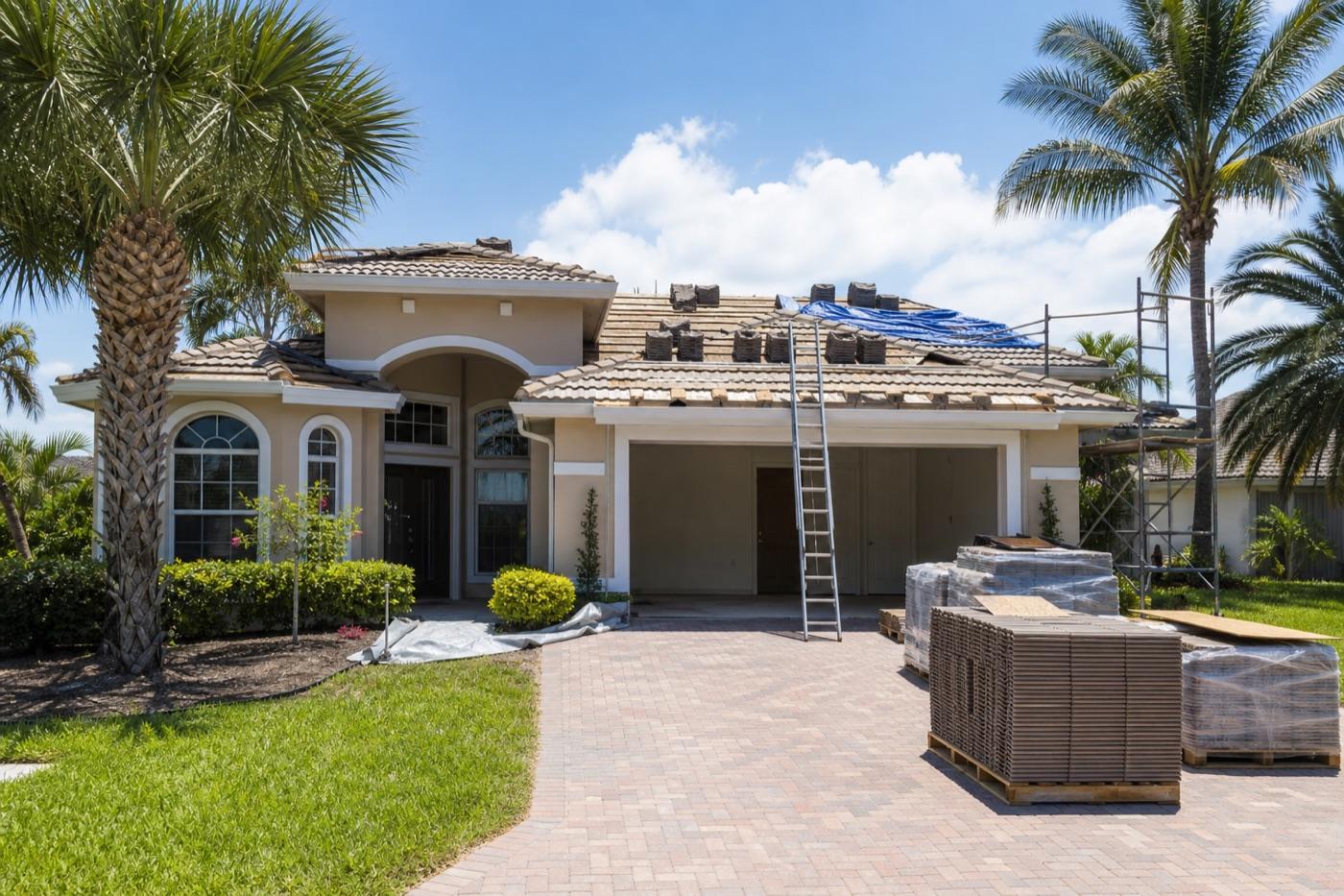Florida investment property undergoing roof work with materials staged outside
